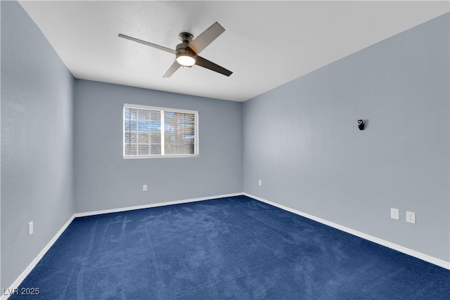 unfurnished room with ceiling fan and dark carpet