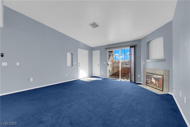 unfurnished living room featuring carpet, lofted ceiling, and a tile fireplace