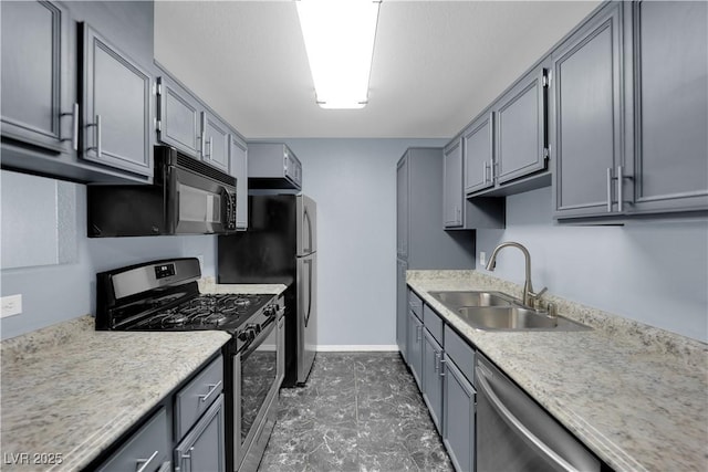 kitchen with gray cabinetry, sink, and stainless steel appliances