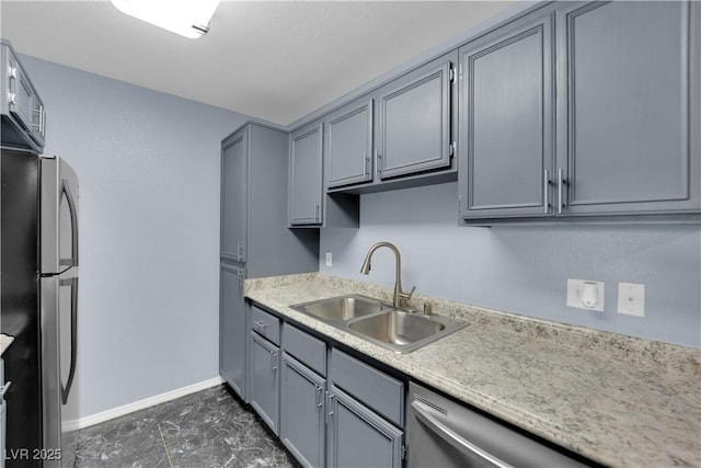 kitchen with gray cabinets, stainless steel fridge, and sink