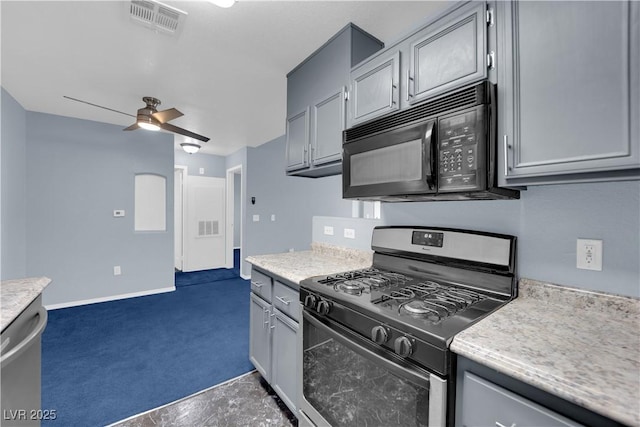 kitchen featuring dark carpet, stainless steel appliances, gray cabinets, and ceiling fan