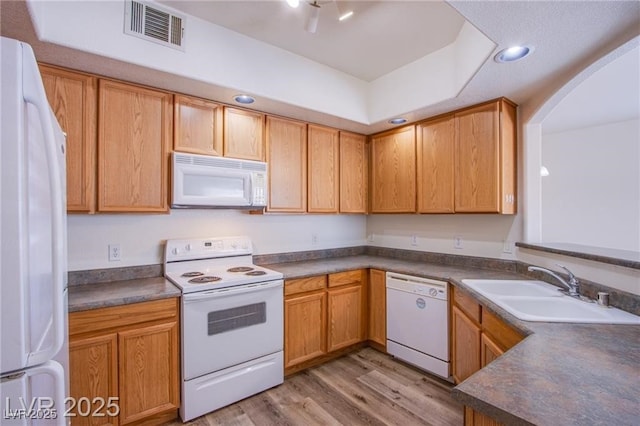 kitchen with white appliances, sink, and light wood-type flooring