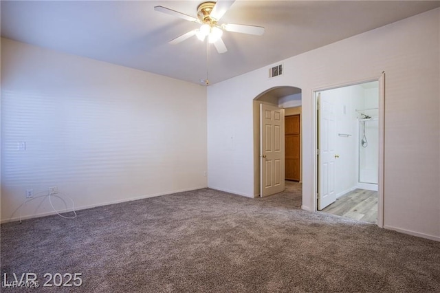 carpeted spare room featuring ceiling fan