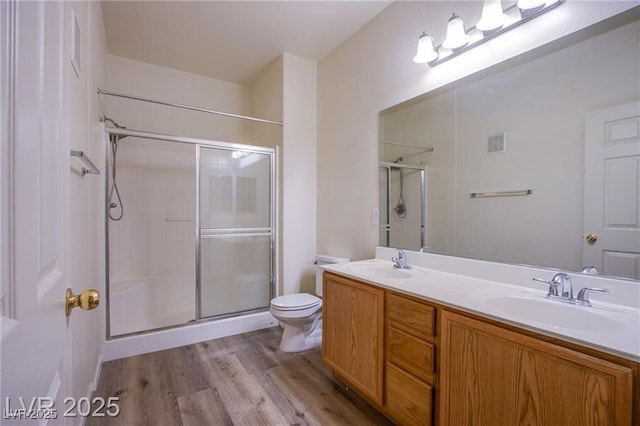 bathroom with vanity, hardwood / wood-style floors, toilet, and walk in shower