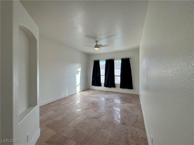 spare room featuring ceiling fan and a textured ceiling