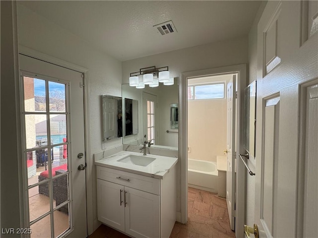 bathroom with vanity and a bathing tub