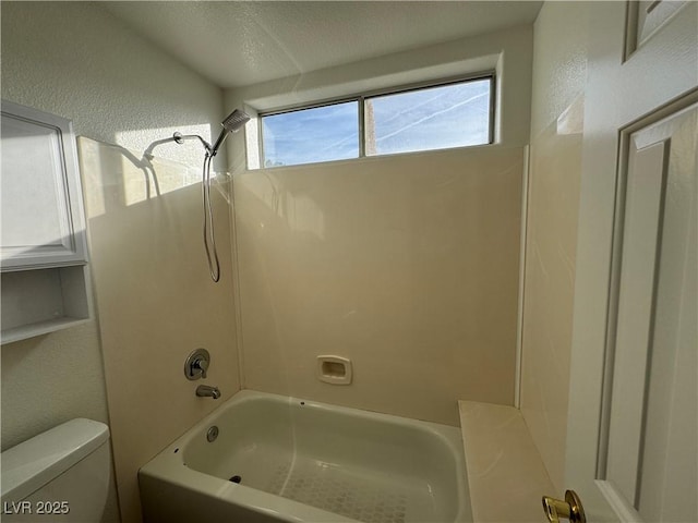 bathroom with shower / tub combination and toilet