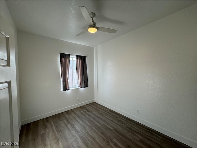 unfurnished room with ceiling fan and dark hardwood / wood-style floors