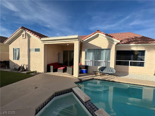 rear view of house with outdoor lounge area, a patio, and a pool with hot tub