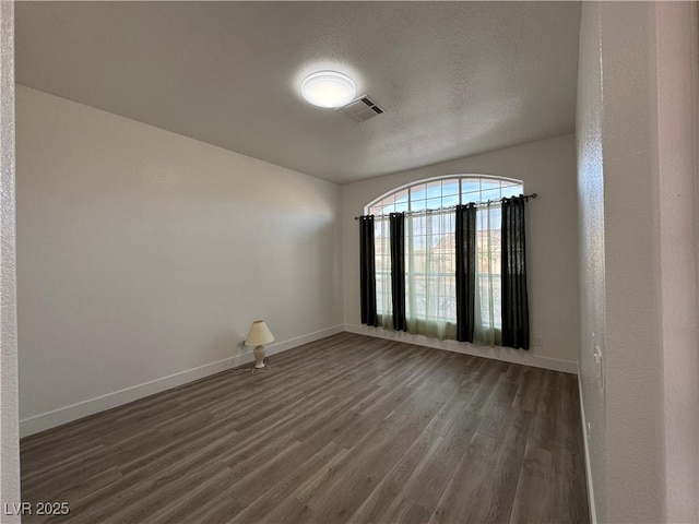 empty room featuring dark wood-type flooring