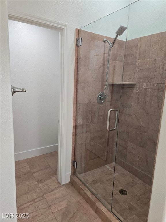 bathroom with a shower with door