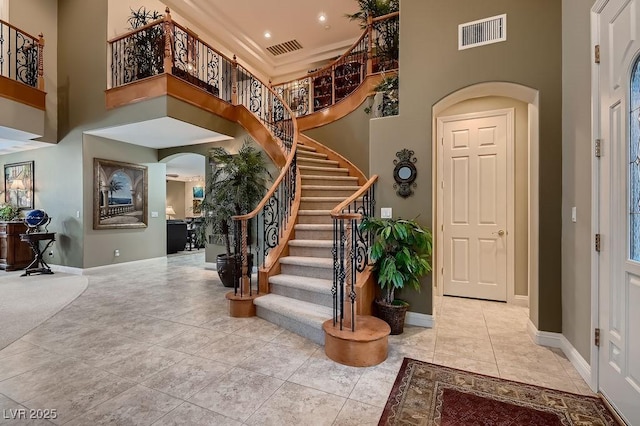 tiled foyer entrance with a high ceiling