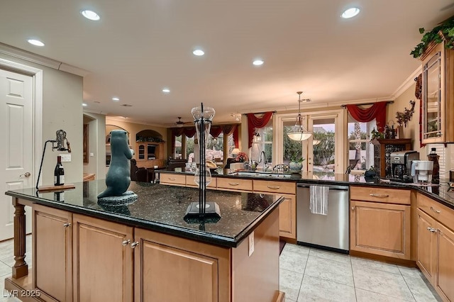 kitchen featuring sink, crown molding, stainless steel dishwasher, pendant lighting, and dark stone counters