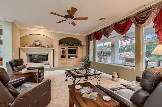 living room featuring ceiling fan and ornamental molding