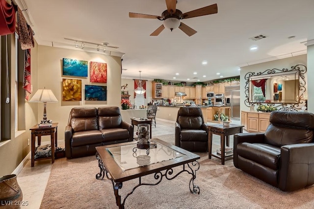 living room with ceiling fan and track lighting