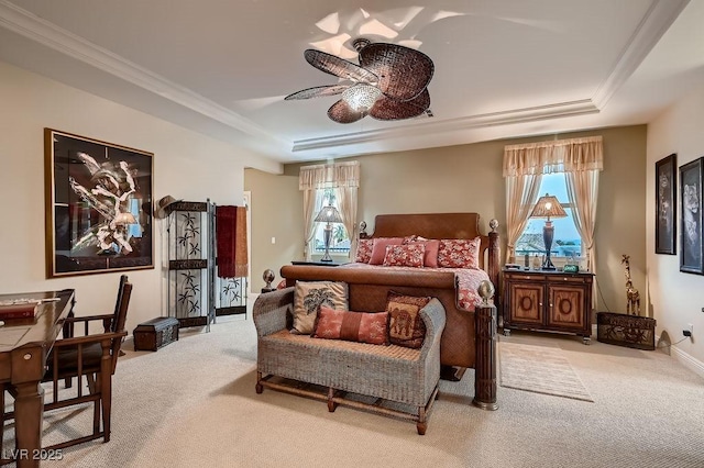 carpeted bedroom featuring crown molding, ceiling fan, and a raised ceiling