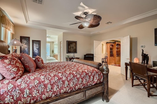 bedroom featuring ensuite bath, ceiling fan, a tray ceiling, ornamental molding, and light carpet