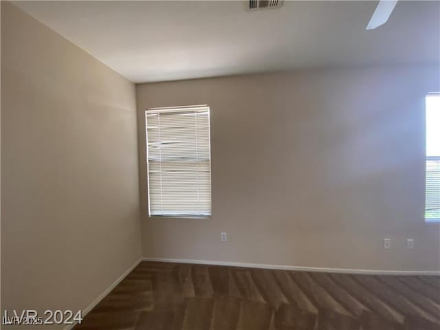 empty room with dark colored carpet