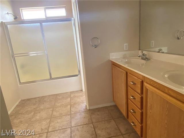 bathroom featuring vanity and enclosed tub / shower combo