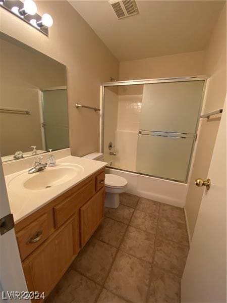 full bathroom featuring shower / bath combination with glass door, vanity, and toilet