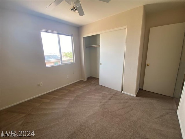 unfurnished bedroom with carpet flooring, a closet, and ceiling fan