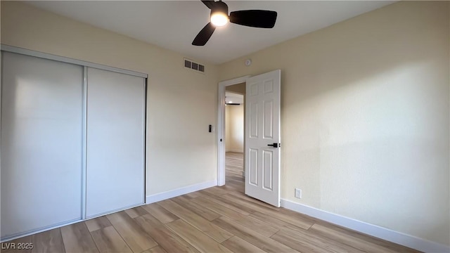 unfurnished bedroom featuring a closet, ceiling fan, and light hardwood / wood-style floors