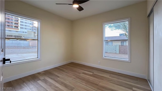 empty room with light hardwood / wood-style flooring and ceiling fan