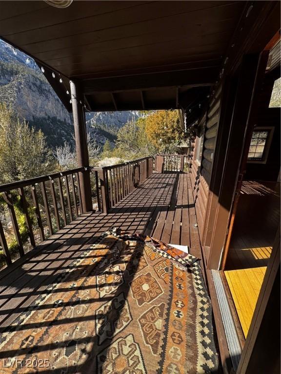 wooden terrace featuring a mountain view