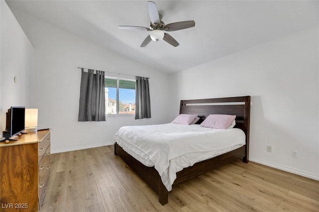 bedroom featuring light wood-type flooring, vaulted ceiling, and ceiling fan