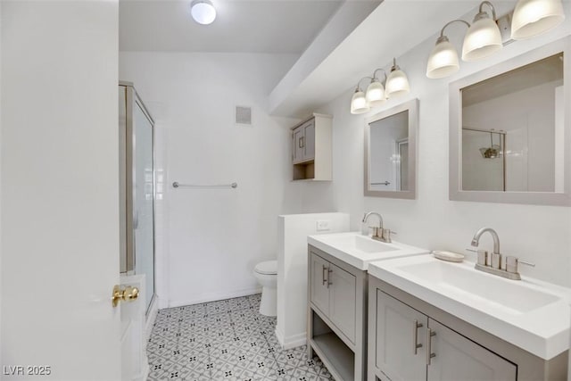 bathroom with a shower with door, vanity, and toilet