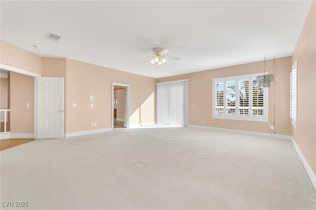 unfurnished room featuring light colored carpet and ceiling fan