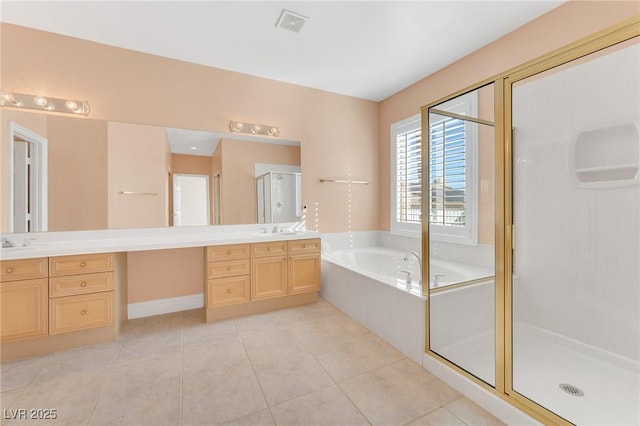 bathroom featuring independent shower and bath, tile patterned flooring, and vanity