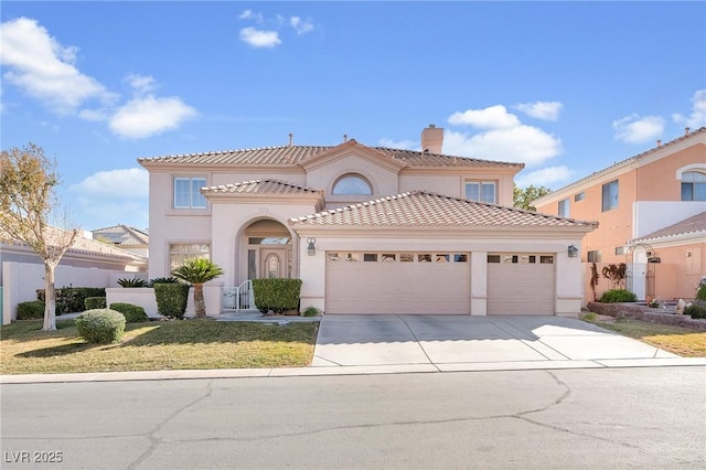 mediterranean / spanish home featuring a front yard and a garage