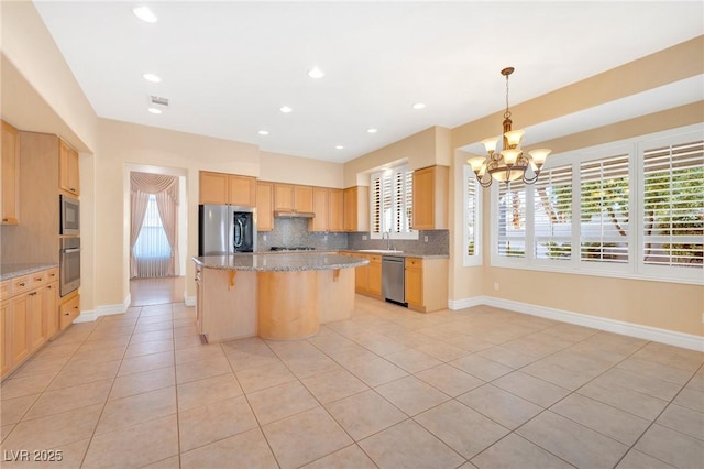 kitchen featuring sink, a center island, light tile patterned flooring, hanging light fixtures, and appliances with stainless steel finishes