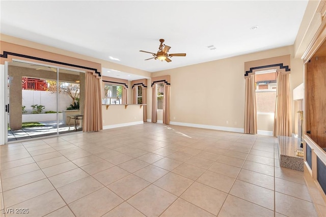 tiled empty room featuring ceiling fan