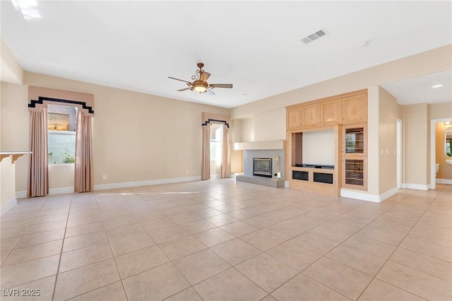 unfurnished living room featuring ceiling fan and light tile patterned floors