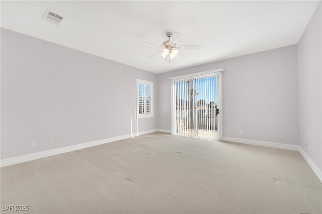 carpeted spare room with ceiling fan