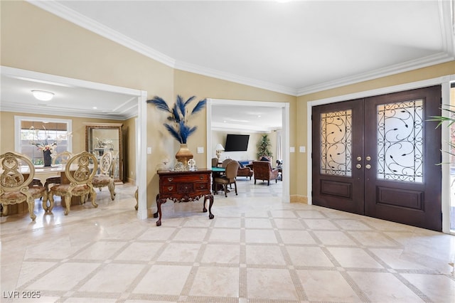 entrance foyer featuring crown molding and french doors