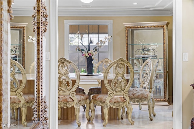 dining room featuring crown molding