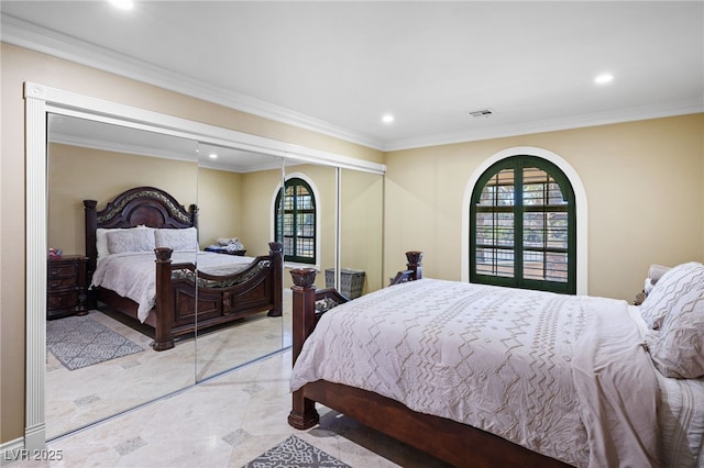 bedroom with multiple windows, a closet, french doors, and ornamental molding