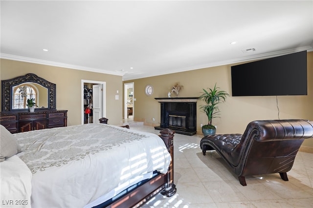 tiled bedroom featuring a spacious closet, a closet, and ornamental molding