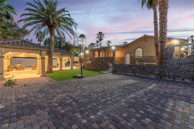 patio terrace at dusk with a lawn