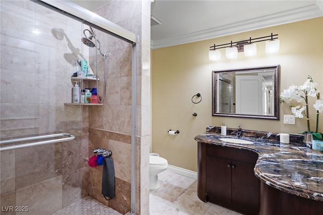 bathroom featuring vanity, toilet, a shower with shower door, and crown molding