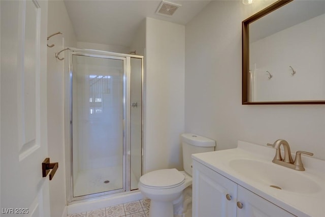 bathroom featuring tile patterned flooring, vanity, toilet, and an enclosed shower