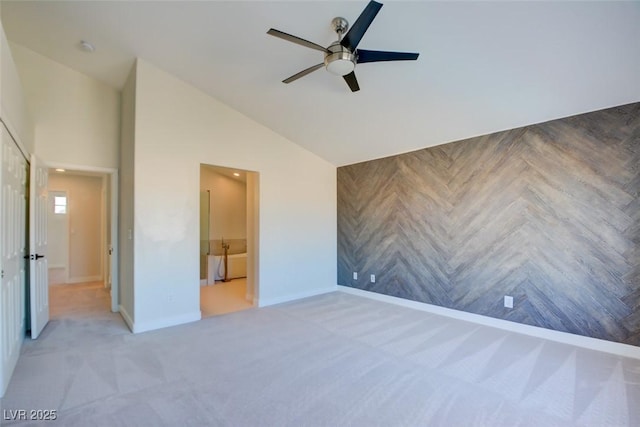 unfurnished bedroom featuring ceiling fan, carpet floors, and vaulted ceiling