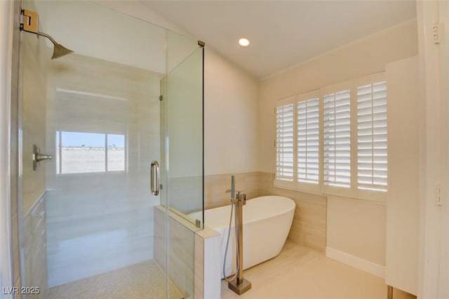 bathroom featuring plus walk in shower, tile patterned floors, and tile walls