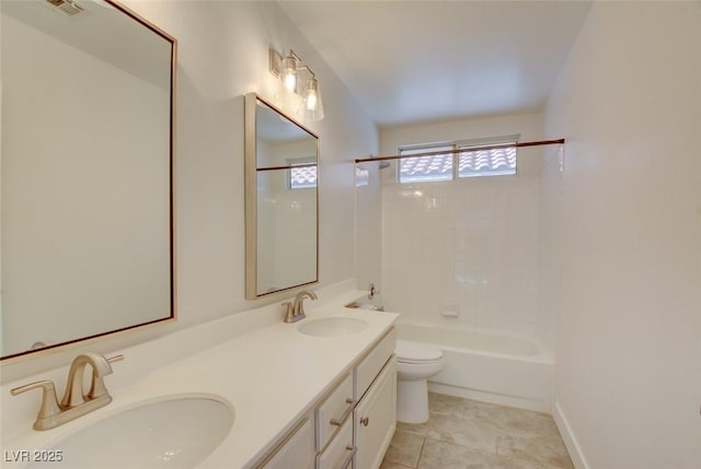 full bathroom with tile patterned floors, vanity, tiled shower / bath combo, and toilet