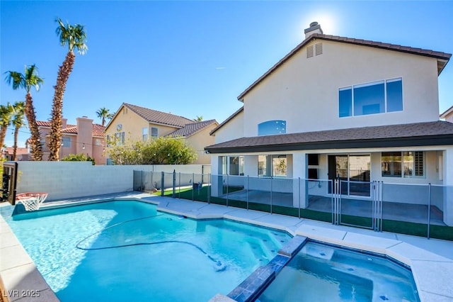 view of swimming pool featuring an in ground hot tub