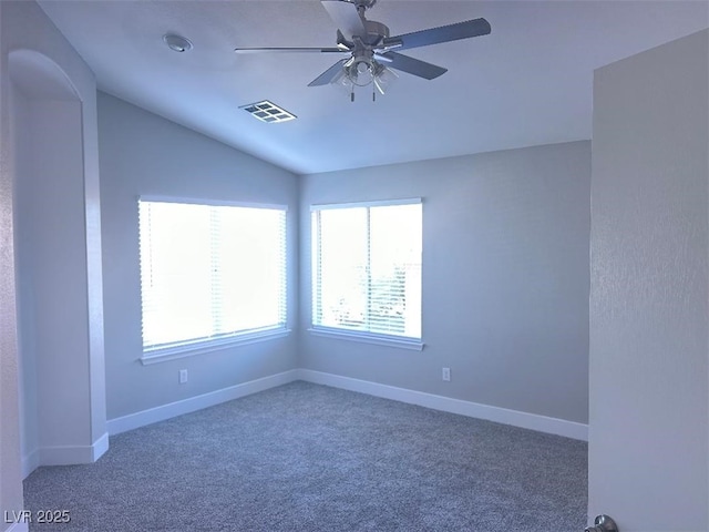 carpeted empty room with ceiling fan and vaulted ceiling