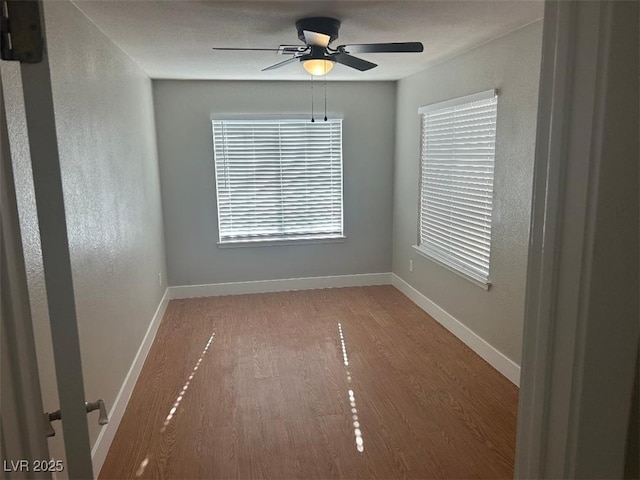 unfurnished room featuring hardwood / wood-style floors and ceiling fan